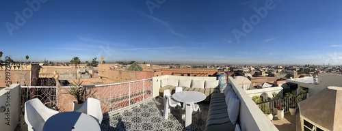 Morocco, Africa: panoramic view on a sunny day from a high rooftop, skyline of Marrakech, one of the four Imperial cities of Morocco situated west of the foothills of the Atlas Mountains   #591976212