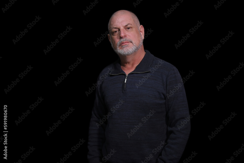 Fototapeta premium portrait of older bearded man pensive and watching isolated on black background