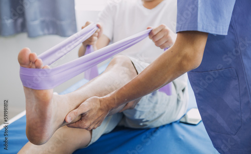 Doctor or Physiotherapist working examining treating injured arm of athlete male patient  stretching and exercise  Doing the Rehabilitation therapy pain in clinic.
