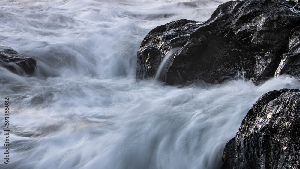 Tide water washing over rocks, Cox Bay Beach, Vancouver Island; British Columbia, Canada Tide water washing over rocks, Cox Bay Beach, Vancouver Island; British Columbia, Canada