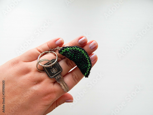 Colorful bright key chain in hand