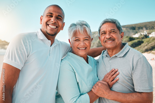 Happy, hug and a portrait of a family at the beach for bonding and quality time on the weekend. Smile, relax and a senior mother and father hugging with an adult man during a holiday at the sea