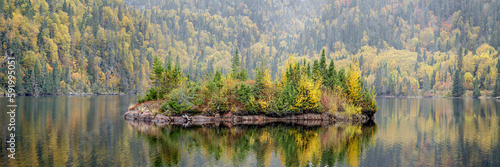 Picturesque autumn coloured landscape with a small island in a lake; Terrace Bay, Ontario, Canada