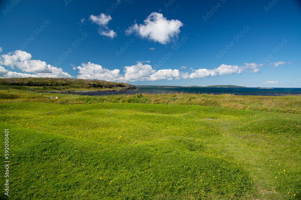 Outline and mounds in the grass containing an ancient Viking building site; L'Anse aux Meadows, Newfoundland and Labrador, Canada Outline and mounds in the grass containing an ancient Viking building site; L'Anse aux Meadows, Newfoundland and Labrador, Canada