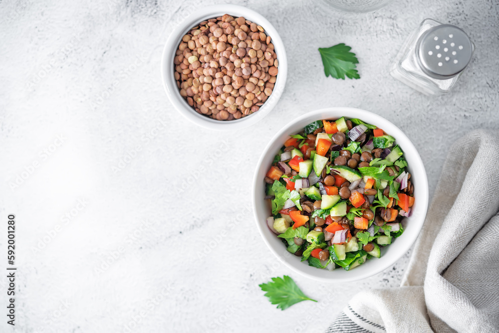 Green lentil red bell pepper cucumber parsley salad in a bowl Green lentil red bell pepper cucumber parsley salad in a bowl