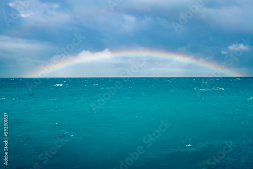 Rainbow arcs over the Great Barrier Reef, the world's largest coral reef; Queensland, Australia photo