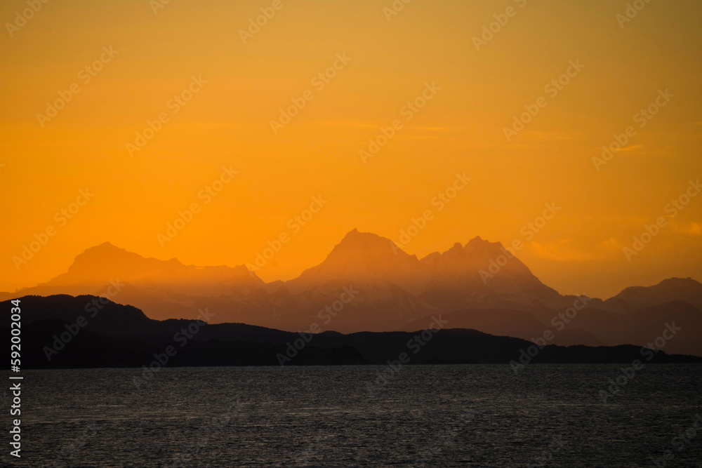 Sunset over distant mountains and Beagle Channel; Ushuaia, Tierra del Fuego, Argentina Sunset over distant mountains and Beagle Channel; Ushuaia, Tierra del Fuego, Argentina