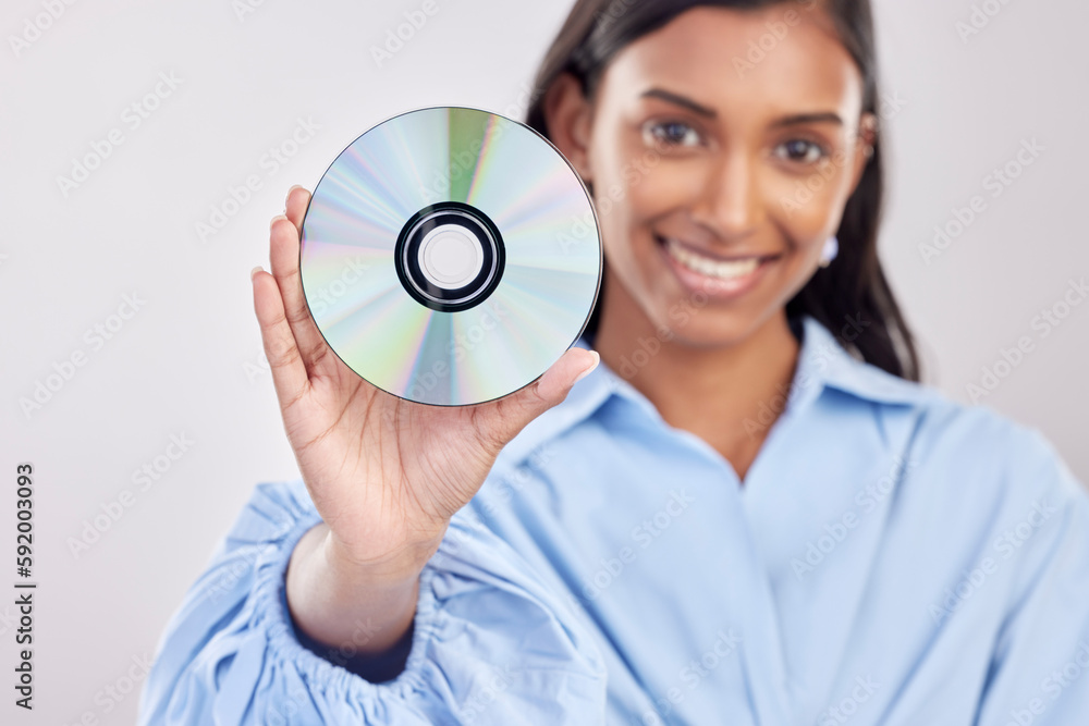 Woman, compact disk and smile in studio portrait for programming, software and information technology. Young indian girl, cd and happy with movie, music and data storage for media by white background Woman, compact disk and smile in studio portrait for programming, software and information technology. Young indian girl, cd and happy with movie, music and data storage for media by white background