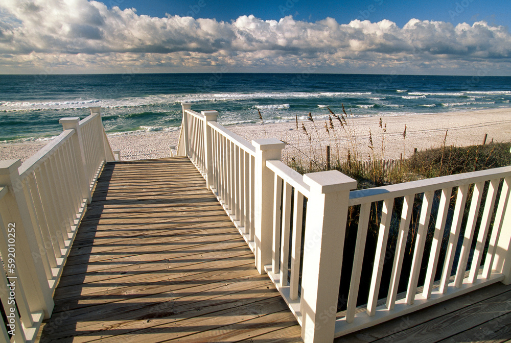 Boardwalk leads to an empty beach along the Florida coast, USA; Seaside, Florida, United States of America Boardwalk leads to an empty beach along the Florida coast, USA; Seaside, Florida, United States of America