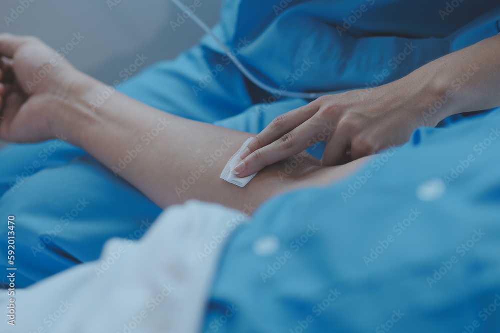 Women Asian doctors hold the patient hand and encourage and provide medical advice While checking the patient health in bed. Concept of Care and compassion, antenatal care, Threatened abortion Women Asian doctors hold the patient hand and encourage and provide medical advice While checking the patient health in bed. Concept of Care and compassion, antenatal care, Threatened abortion