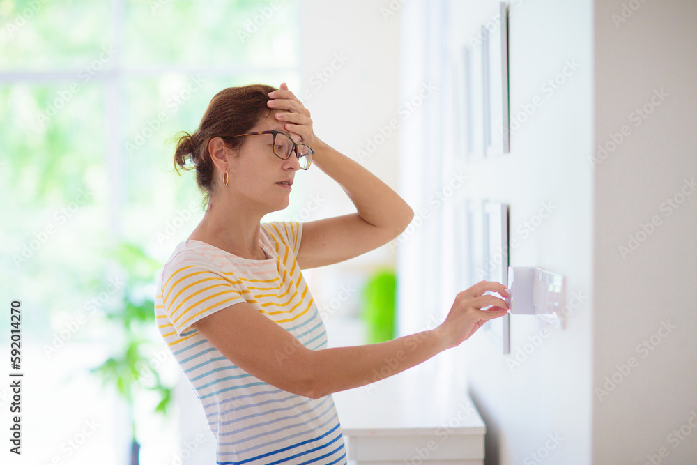 Woman adjusting thermostat. Central heating. Woman adjusting thermostat. Central heating.