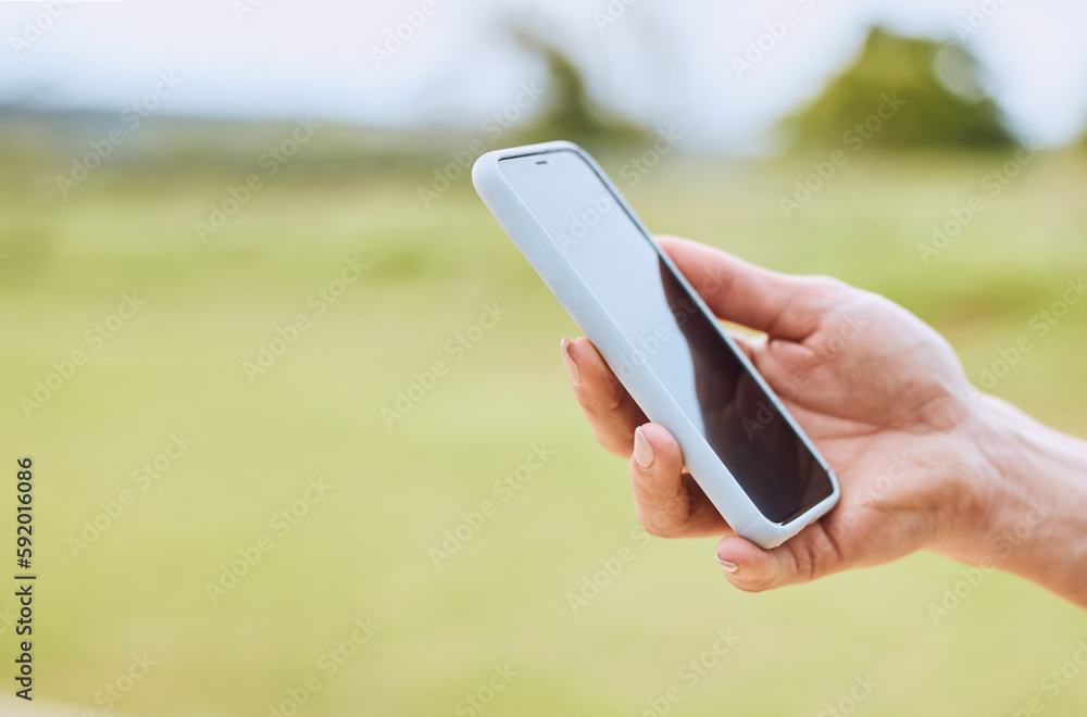 Hand, phone and person use gps online on mobile app to navigate on a field with internet connection for a smartphone. Cellphone, mockup and closeup of web search on a website outdoors in nature