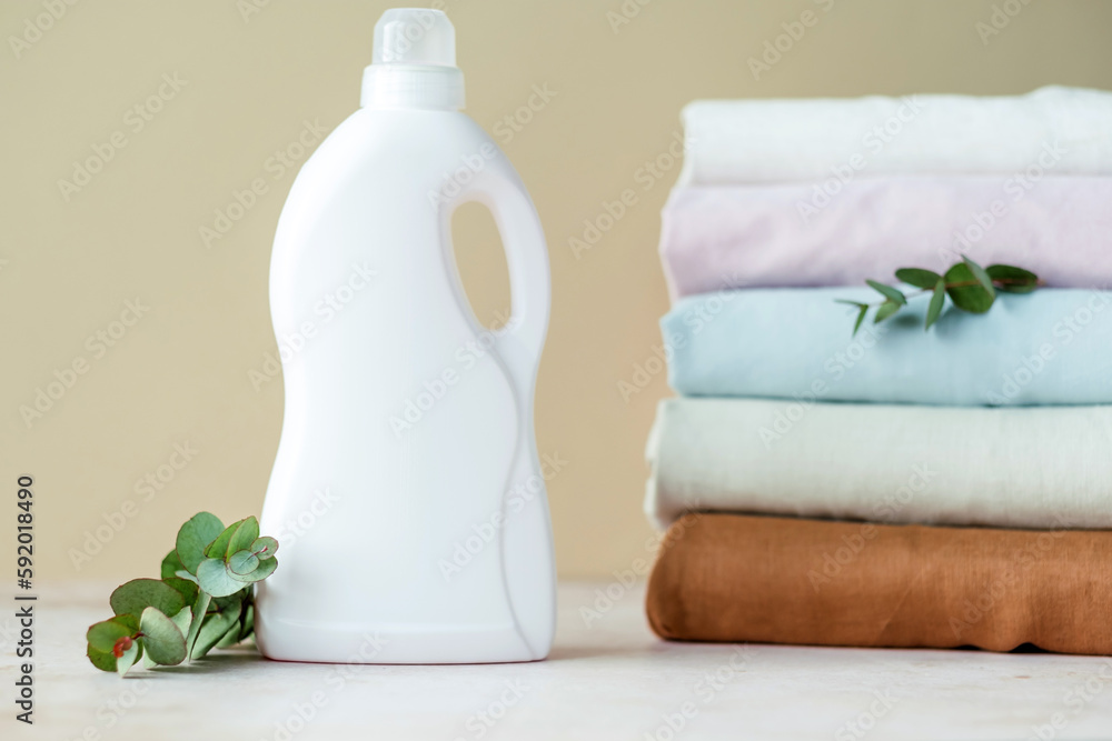 Mockup of a white plastic bottle with handle with for gel or liquid powder, gel, for place for design presentation with a branch of eucalyptus. Mockup of a white plastic bottle with handle with for gel or liquid powder, gel, for place for design presentation with a branch of eucalyptus.