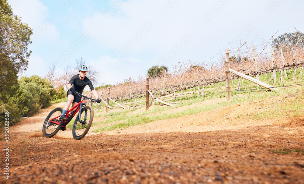 Riding, nature and a man on a bike for cycling, fitness or practice for a race in the countryside. Adventure, sports and a cyclist on a bicycle for training, sports and outdoor cardio exercise