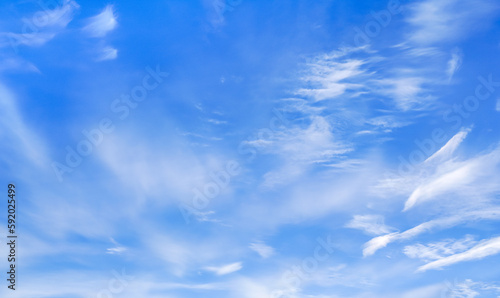 Bright blue sky with fine cirrus clouds