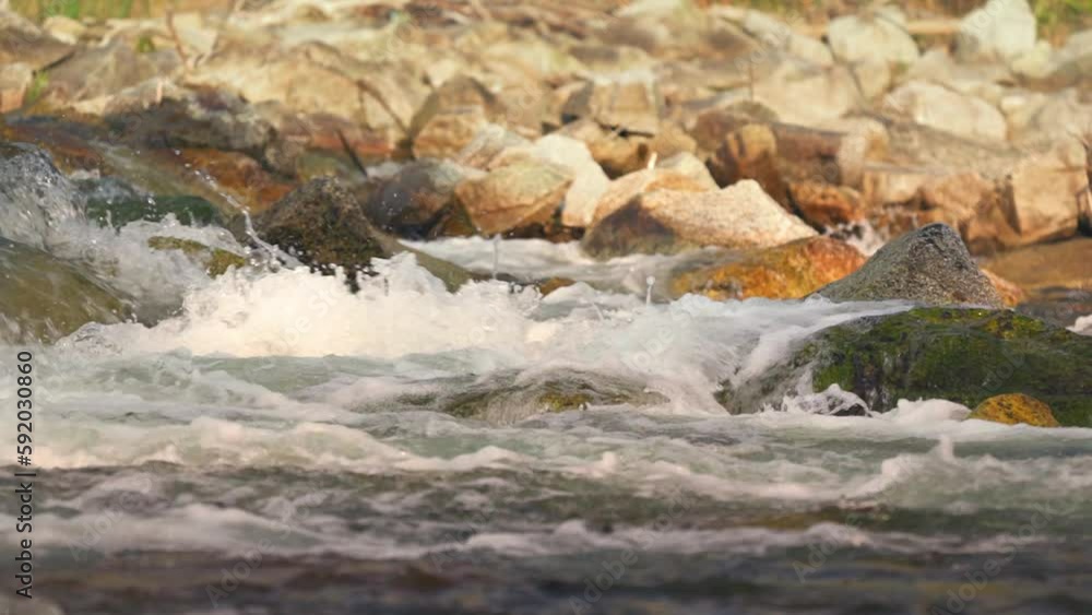 River flowing over rocks cascade on sunny day, closeup detail, slow motion video River flowing over rocks cascade on sunny day, closeup detail, slow motion video