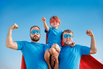 Grandfather, father and son having fun outdoor. Fathers day