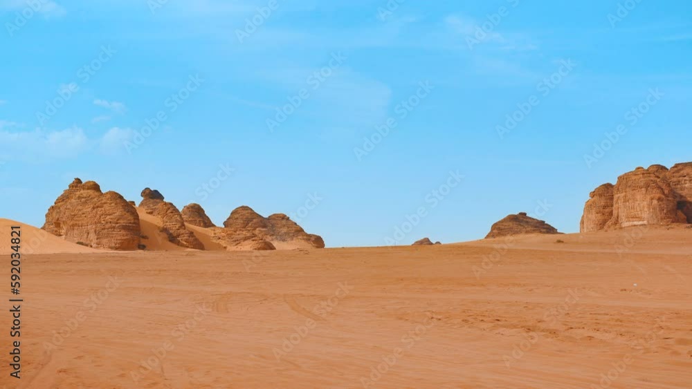 Typical desert landscape in Al Ula, Saudi Arabia, sand with some mountains locals at distance Typical desert landscape in Al Ula, Saudi Arabia, sand with some mountains locals at distance