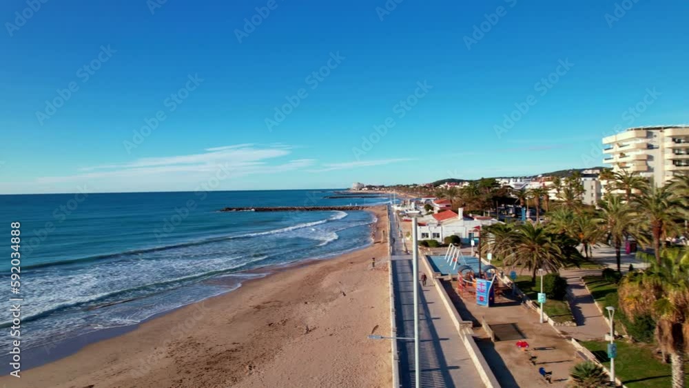 Aerial panoramic view of coastal village at seashore, old town, Sant Bartomeu i Santa Tecla de Sitges during sunny day in mediterranean town of Sitges, Province of Barcelona, Spain. Film intro. 4K Aerial panoramic view of coastal village at seashore, old town, Sant Bartomeu i Santa Tecla de Sitges during sunny day in mediterranean town of Sitges, Province of Barcelona, Spain. Film intro. 4K
