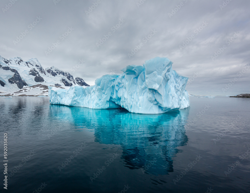Impressive iceberg with blue ice in Antarctica, scenic landscape in Antarctic Peninsula Impressive iceberg with blue ice in Antarctica, scenic landscape in Antarctic Peninsula