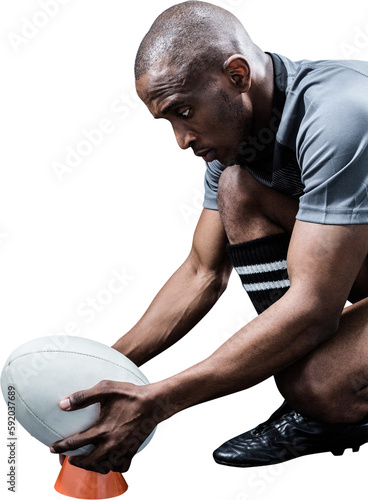 Sportsman keeping rugby ball on kicking tee