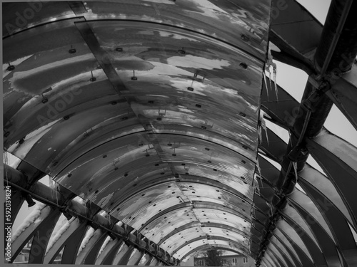 interesting metal structure of the bridge in winter, black and white, view from below 
