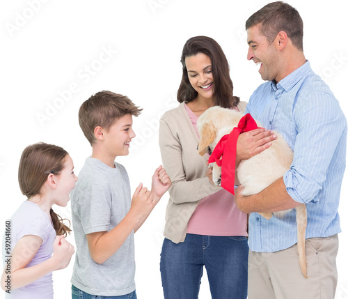 Parents gifting puppy to children against white background