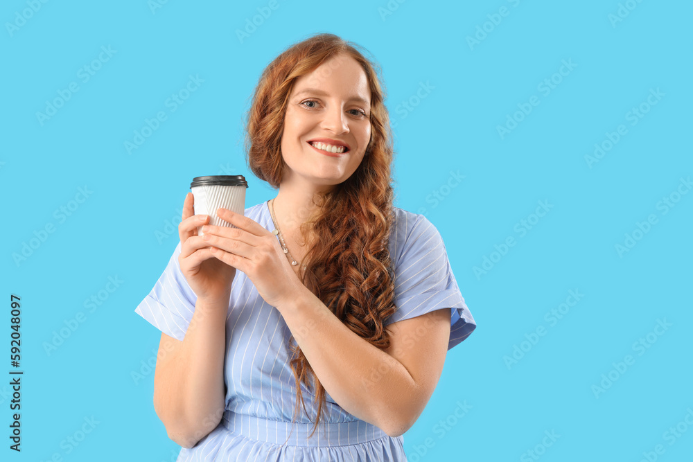 Beautiful redhead woman with cup of coffee on blue background Beautiful redhead woman with cup of coffee on blue background