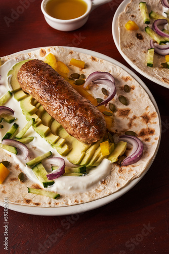 vegan adana kebab with vegetables on flatbread