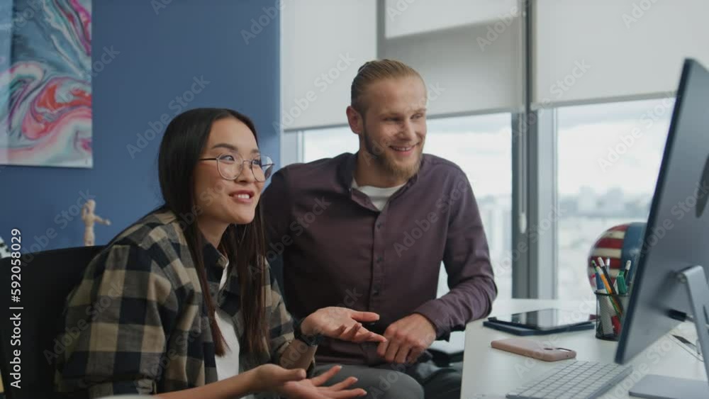Smiling woman explaining video call computer. Colleagues presenting project Smiling woman explaining video call computer. Colleagues presenting project