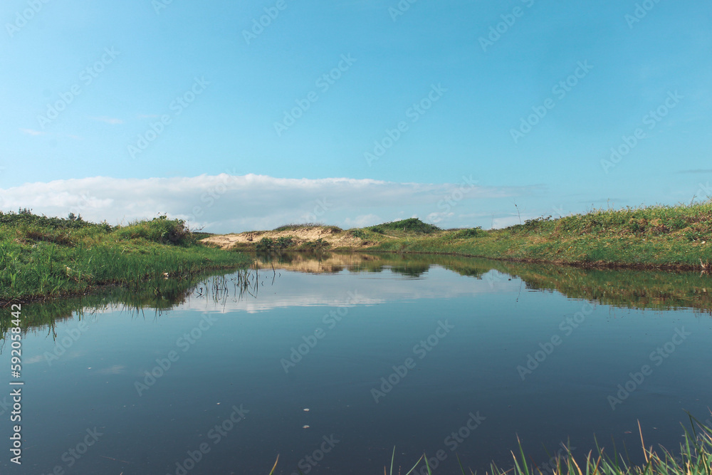 reflection in water to the sea on Ilha Comprida beach, south coast of São Paulo, Brazil.