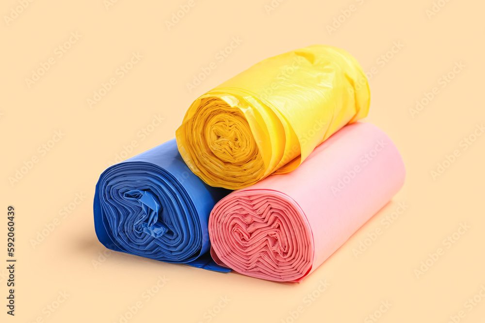 Different rolls of garbage bags on beige background Different rolls of garbage bags on beige background