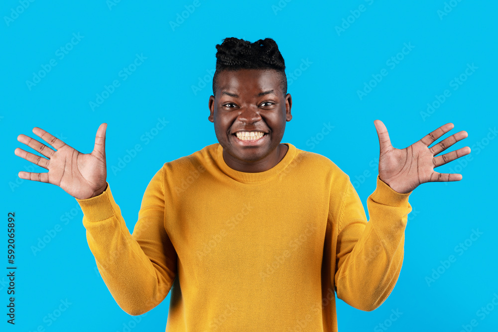 Portrait Of Surprised Black Young Man Spreading Hands With Excitement Portrait Of Surprised Black Young Man Spreading Hands With Excitement
