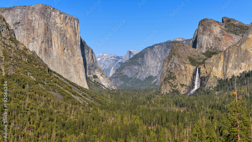 Yosemite Valley - A sunny Spring evening view of Yosemite Valley, with El Capitan at left, Bridalveil Fall at right and Half Dome at center in background. Yosemite National Park, California, USA.