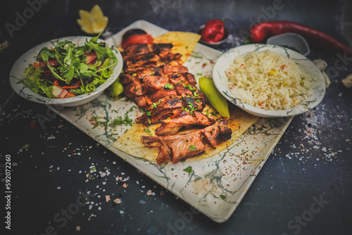Grilled Lamb Ribs with Sides: Flavorful Meat, Fresh Salad, Turkish Rice, Gourmet Food, Delicious Meal, Tasty Combination, Mediterranean Cuisine, Culinary Delight