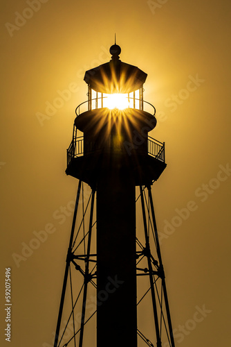 Golden Lighthouse with Sun Burst