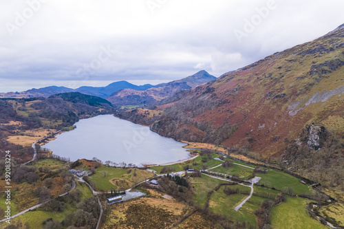 Top aerial panoramic view of a lake surrounded by mountains at Snowdonia national park in North Wales. High quality photo