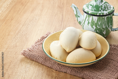 Nopia or Ndog Gluduk, Indonesian traditional snack, made from flour dough filled with brown sugar and baked
 photo