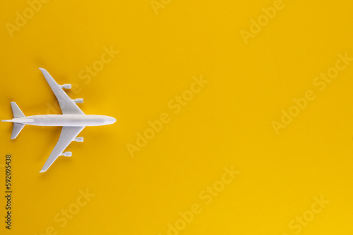 Close up of airplane model on yellow background with copy space
