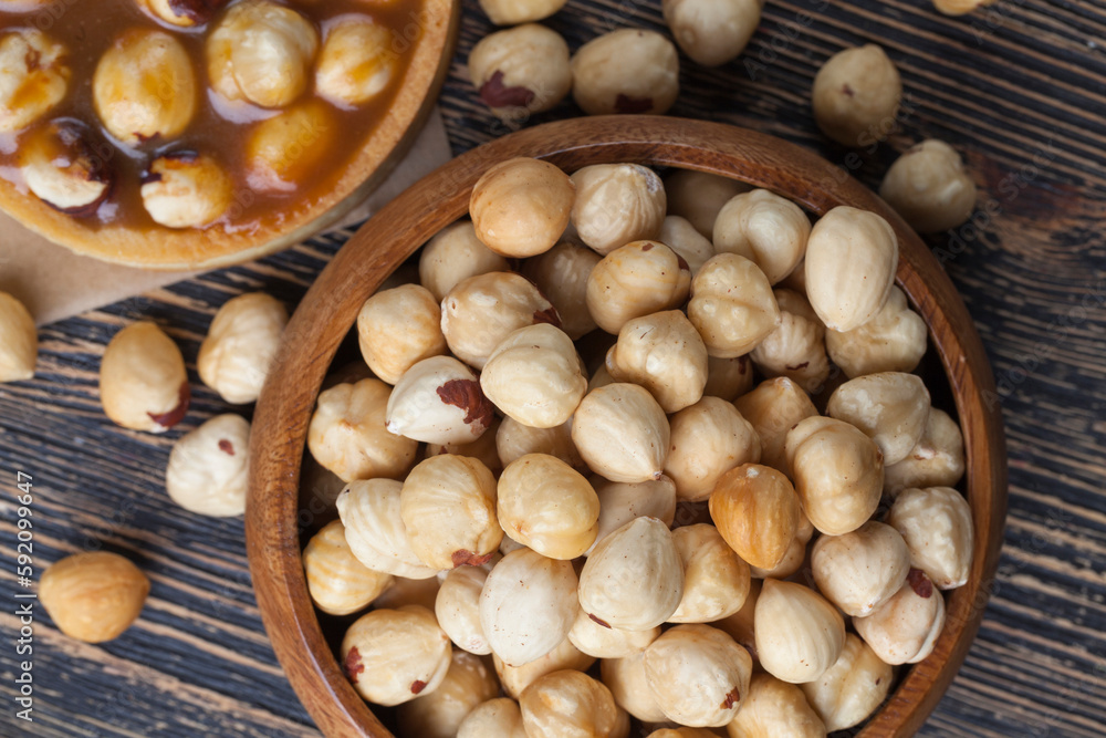 Roasted and shelled hazelnuts on the table, crisp fresh hazelnut harvest on the table in the kitchen Roasted and shelled hazelnuts on the table, crisp fresh hazelnut harvest on the table in the kitchen