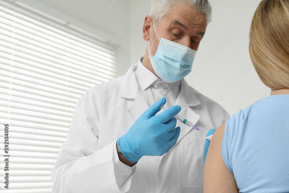 Doctor giving hepatitis vaccine to patient in clinic. Space for text Doctor giving hepatitis vaccine to patient in clinic. Space for text