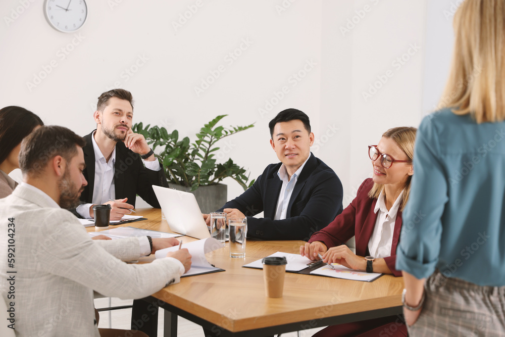 Businesspeople having meeting at table in office Businesspeople having meeting at table in office