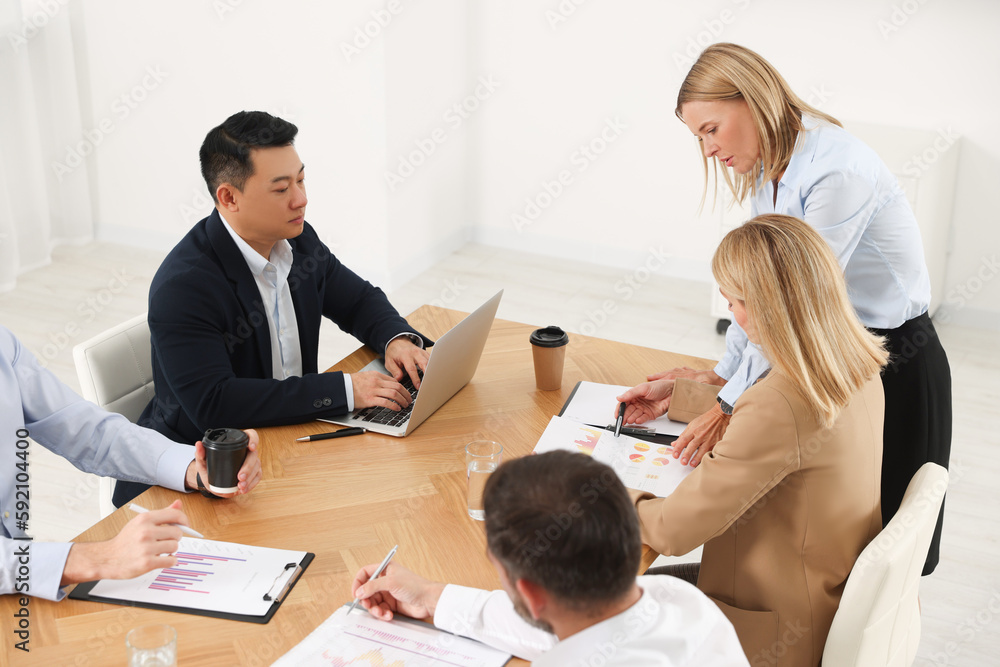 Businesswoman having meeting with her employees in office Businesswoman having meeting with her employees in office
