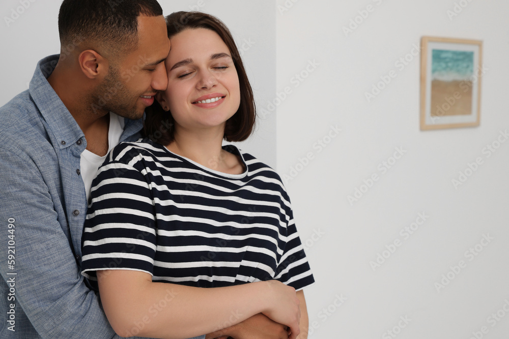 Dating agency. Couple hugging near window at home, space for text Dating agency. Couple hugging near window at home, space for text