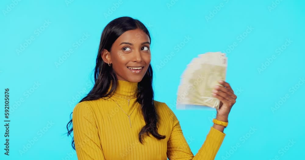 Mockup, studio portrait or Indian woman with cash or money isolated on blue background with a smile. Wealthy, finance or happy rich girl winner fanning with lottery jackpot by winning a bonus prize Mockup, studio portrait or Indian woman with cash or money isolated on blue background with a smile. Wealthy, finance or happy rich girl winner fanning with lottery jackpot by winning a bonus prize