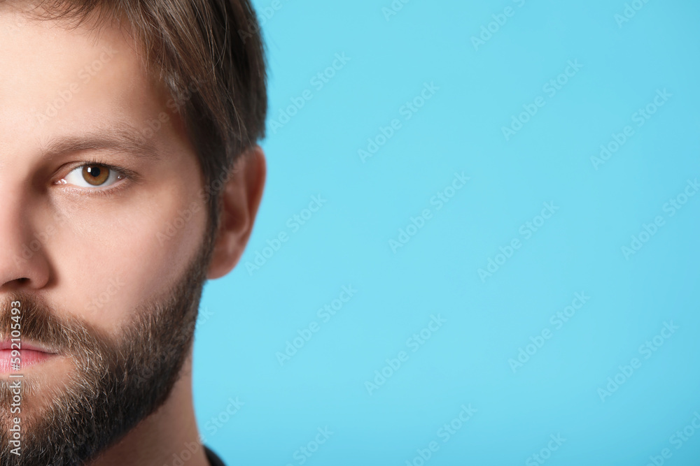 Doctor or medical assistant (male nurse) on turquoise background, closeup. Space for text