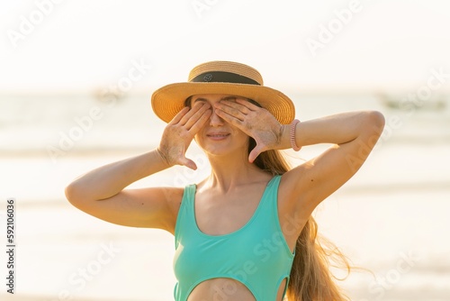 Beautiful woman in bikini on the beach enjoying her holiday and sea breeze © asean studio