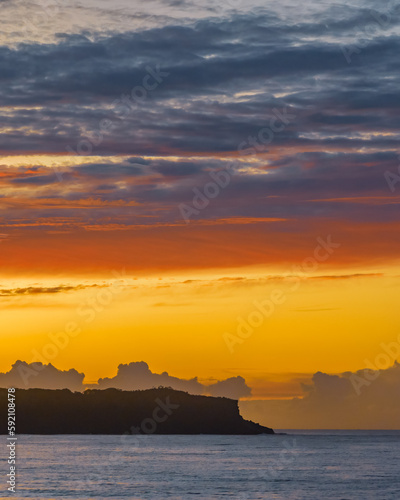 Sunrise and colourful high cloud over the sea and headland © Merrillie