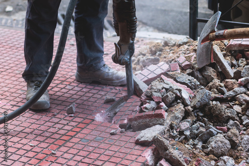 Bilde på lerret Process of sidewalk road repairing with jackhammer, builder worker with pneumati