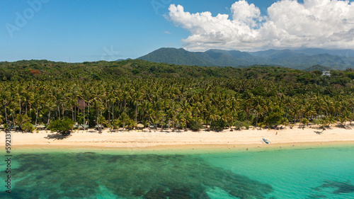Aerial view of Tropical beach with palm trees. Pagudpud, Ilocos Norte, Philippines.